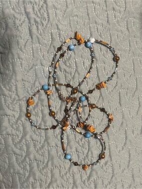 Beaded  neckless with Blue and Gold Accents long can be doubled to 25”